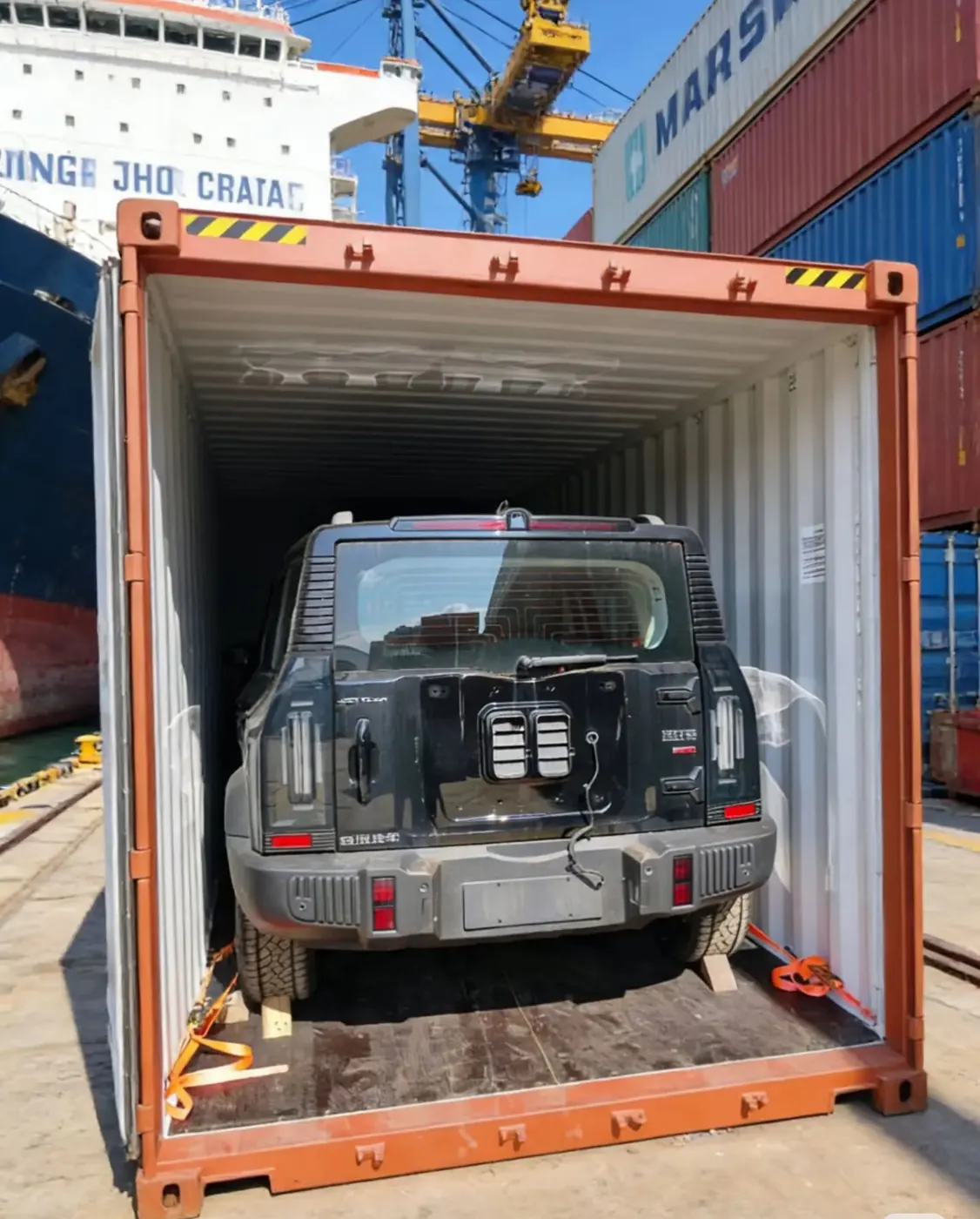 SUV secured with wheel straps inside a 40HQ container